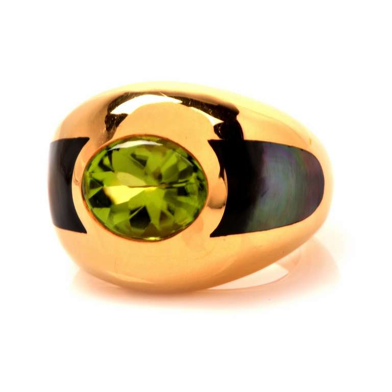 This enchanting peridot and mother-of-pearl ring of French provenance is an authentic ring designed and crafted by Mauboussin jewelers of Paris, bearing the designer/manufacturer’s name, the reference number T48A4654, the French hallmark for gold
