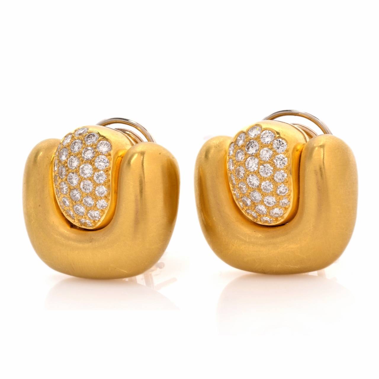 These estate earrings in bold and opulent Retro style are crafted in solid 18K matted yellow gold, weigh 35.3 grams and measure  20 x 22 mm. Incorporating a pair of  stylized 'U' shape yellow gold plaques, surrounding rectangular profiles swathed in