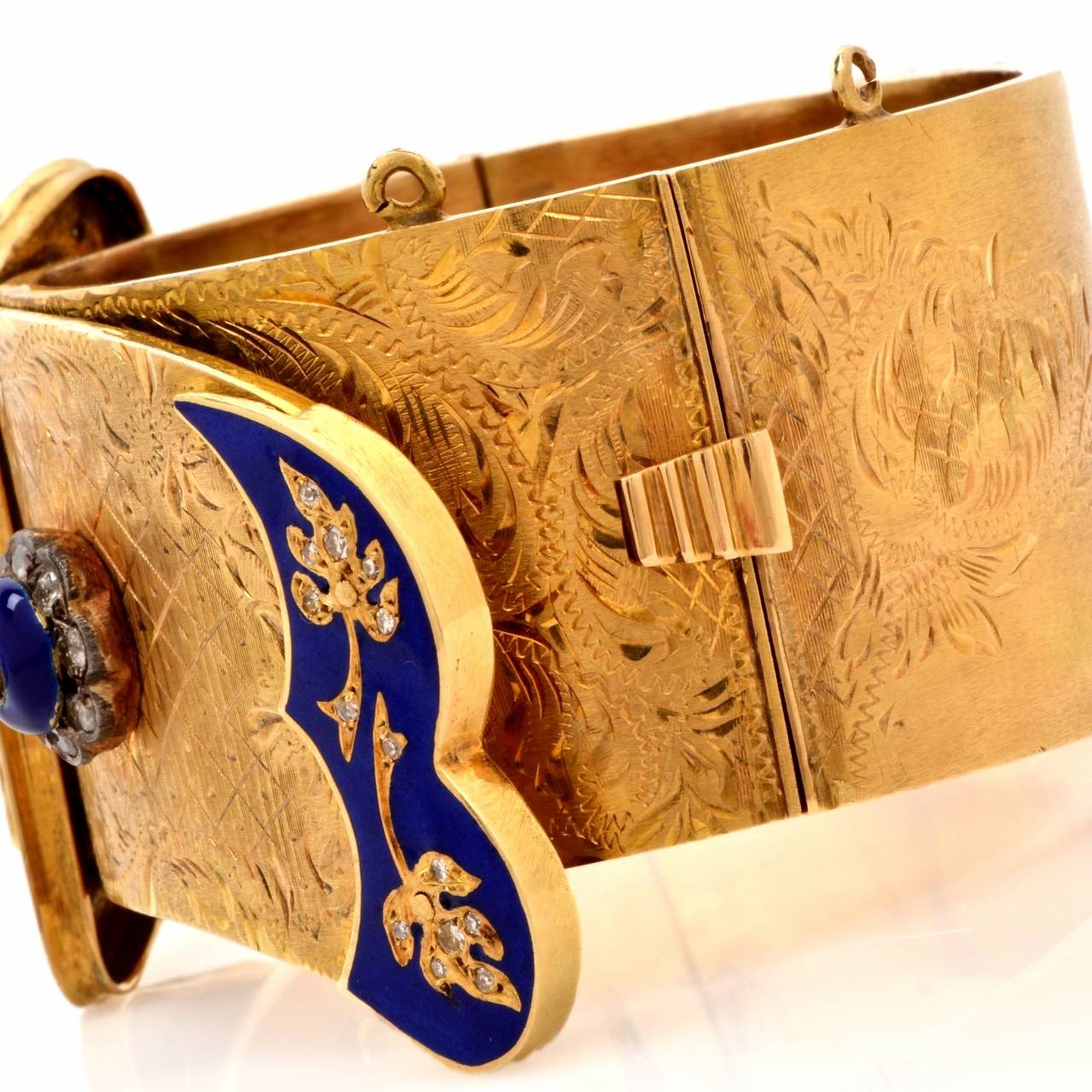 This captivating antique cuff bangle bracelet of immaculate craftsmanship and highly ornate aesthetic is crafted in solid 18K yellow gold, weighing 67.8 grams and measuring 6