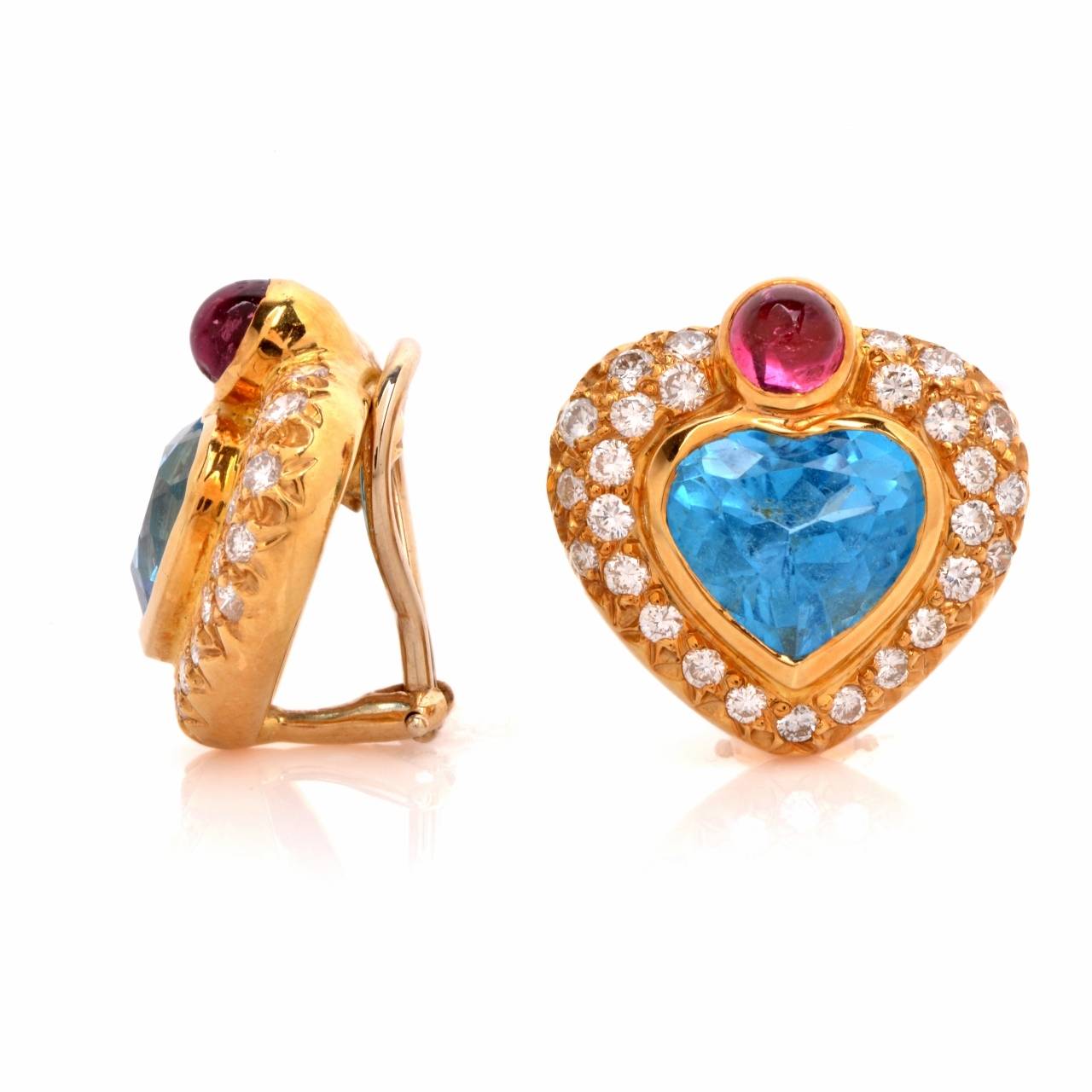 These vividly colored, romantically inspired 1980’s clip-on earrings are crafted in solid 18K yellow gold, weighing 16.2 grams and measuring 20 x 20 mm. Incorporating a pair of heart-shaped profiles, these colorful earrings are centered with