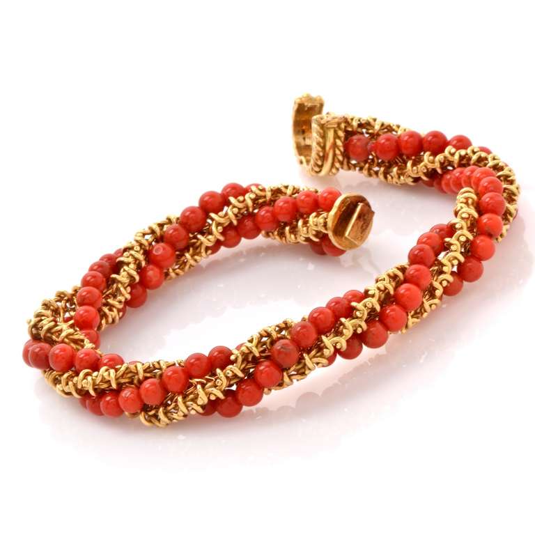 This vintage French bracelet with coral beads is crafted in solid 18K yellow gold, weighs approx. 49.2 grams and measures approx. over 7 3/4