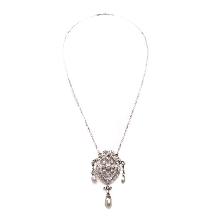 This immaculately crafted Edwardian style pendant necklace of refined aesthetic is crafted in solid 18K white gold, weighs approx. 14.7 grams, while the pendant measures 2.25