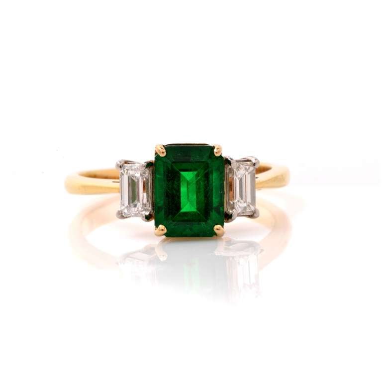 This fine  engagement ring with  GIA certified emerald and diamonds is crafted in a combination of solid platinum and 18K yellow gold and weighs approx. 4.8 grams. Designed in vintage 1950's style of engagement rings, this alluring, bi-tone