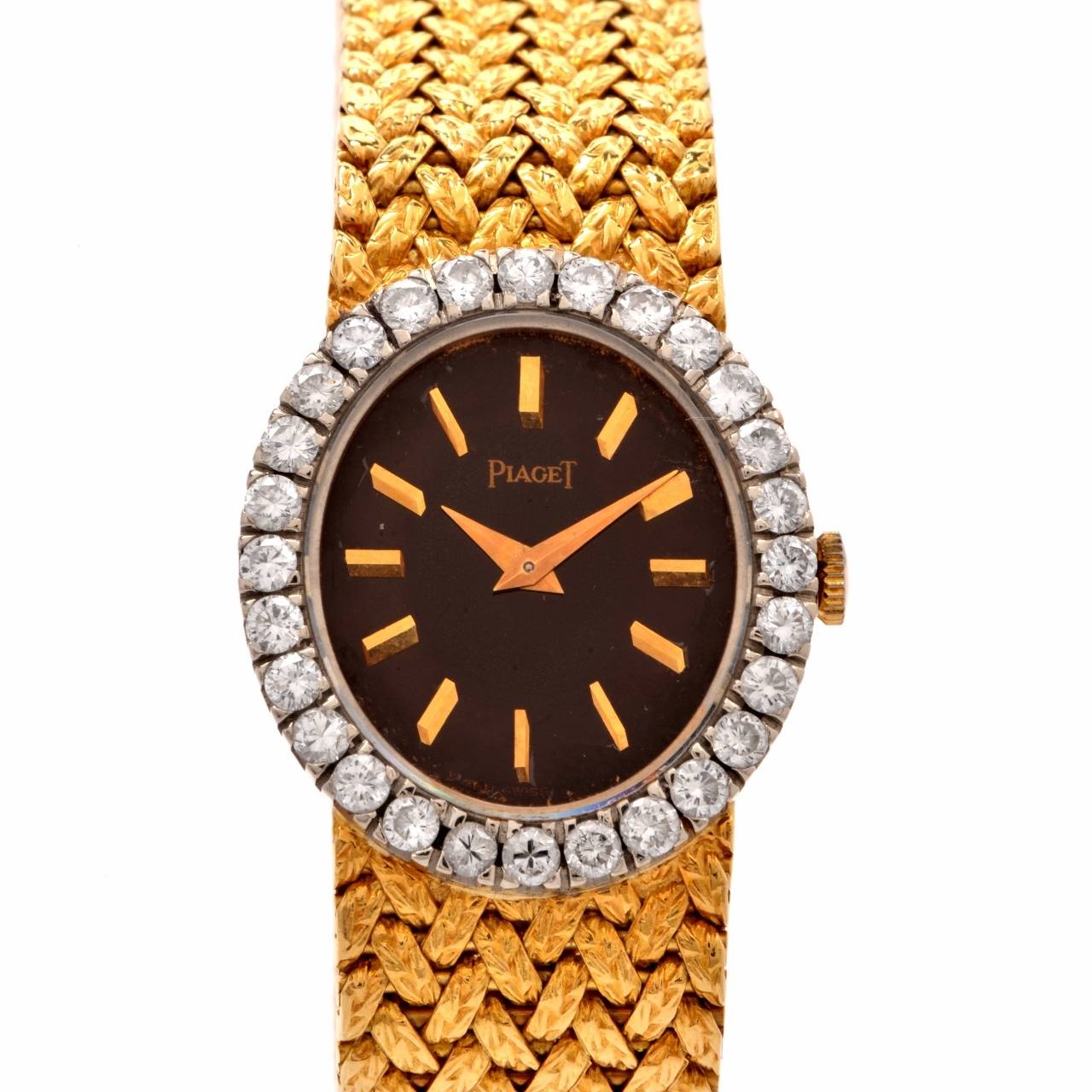 This authentic ladies' vintage circa 1970s Piaget wristwatch of unsurpassed refinement and aesthetic beauty is crafted in solid 18K yellow gold and features  an ovular yellow gold case embellished with a bark finish design border.

This alluring