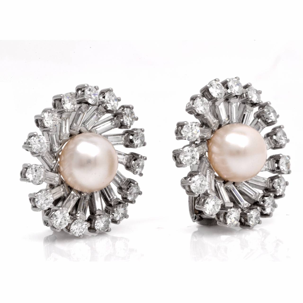 Captivating and  timelessly elegant in style, these eye-catching vintage ear adornments are crafted in platinum, weigh 23.2 grams and measure  25 mm in diameter.  These luxurious earrings depict a pair of lustrous, white  cultured pearls measuring 9