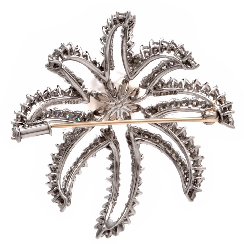 This authentic 1990's Tiffany & Co. Brooch of breath-taking monochromatic beauty is designed as a bursting firework with eight diamond-swathed petal formatted flashes simulating  fireworks. Excuding classic elegance, this designer brooch is crafted