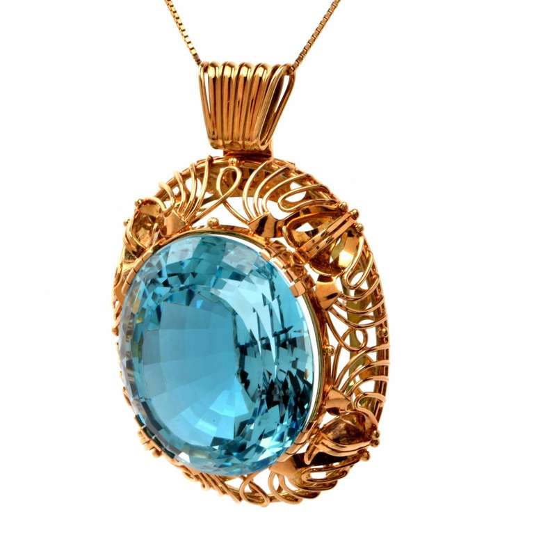 This eye-catching Arts & Crafts inspired aquamarine brooch and pendant is crafted in solid 14K yellow gold, weighing approx. 42.12 grams and measuring approx. 2 3/8