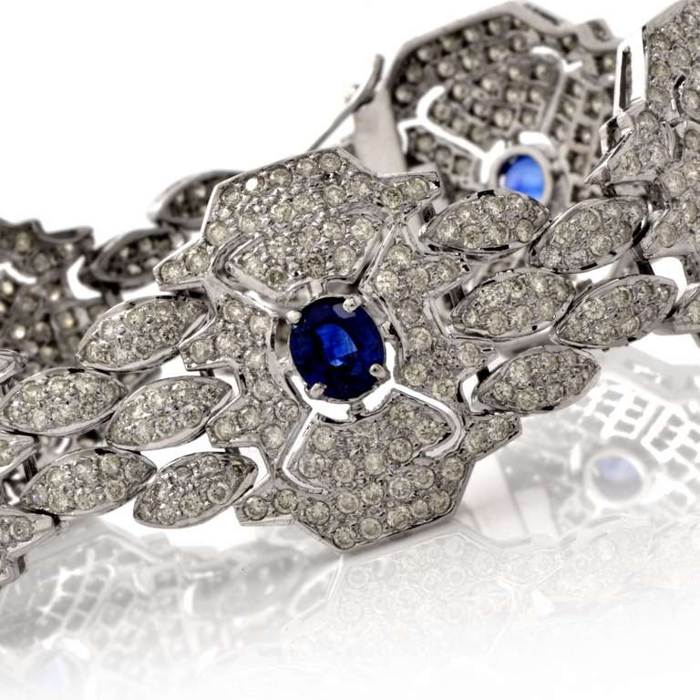 This exquisite vintage bracelet is crafted in solid 18K white gold. This alluring bracelet features 5 genuine oval cut blue sapphires weighing approx: 2.75cttw, prong set. The eye-catching bracelet is encrusted with some 700 pave-set round diamonds