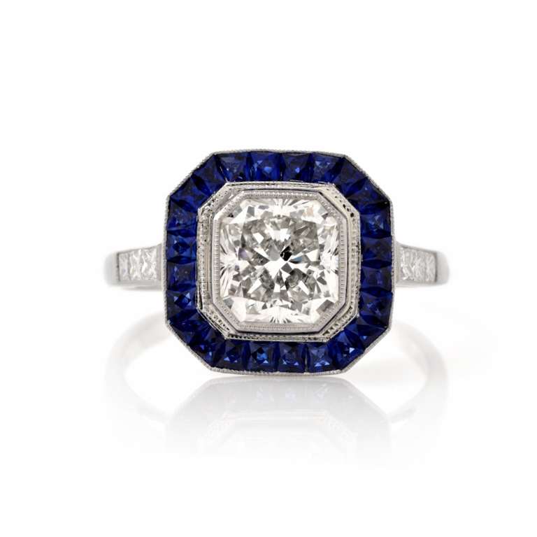 This  stunning Art Deco engagement ring of quintessentially Art Deco  features and color contrast is crafted in  solid platinum, incorporates an enchanting octagonal plaque, exposing at the center a genuine cornered rectangular  modern brilliant-cut