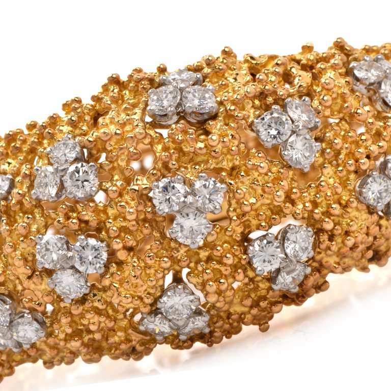 This bracelet of French provenance is a designer piece of jewelry created by Boucheron of Paris, and bears the designer's signature and the French hallmark for authenticity. Crafted in  solid 18K  yellow gold in the 1970's 'nugget texture', this