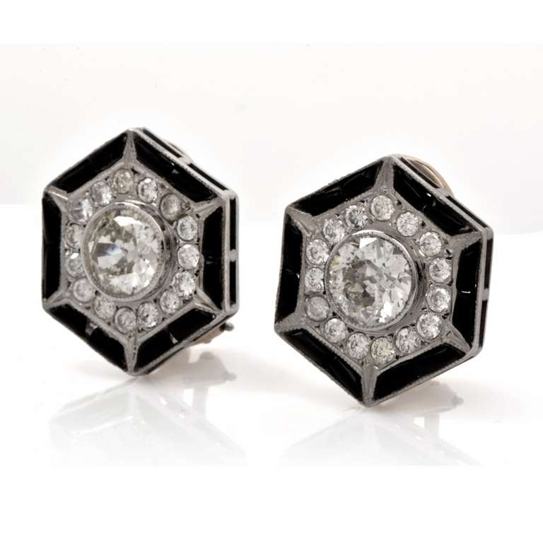 These antique Art Deco earrings of geometrically inspired and color-contrasted design are crafted in platinum and  weigh  approximately 9.00 grams. Designed as enchanting hexagonal plaques, these captivating earrings are centered with a pair of high