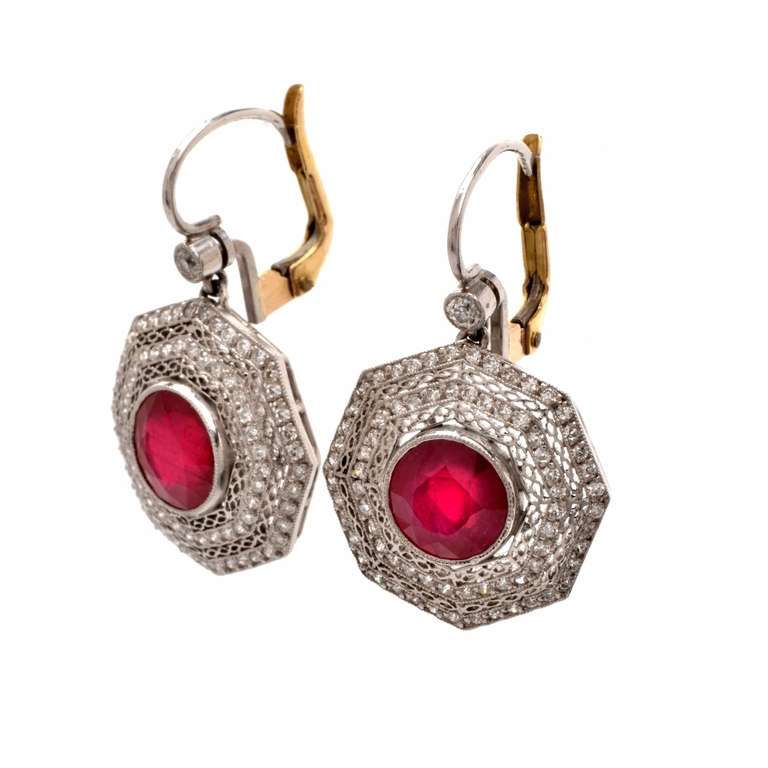 These authentic  antique Art Deco  filigree earrings with rubies and diamonds are crafted in a combination solid platinum with solid 18k yellow backing, weighing approx. 7.9 grams.  Depicting the quintessential features of Art Deco jewelry, these 
