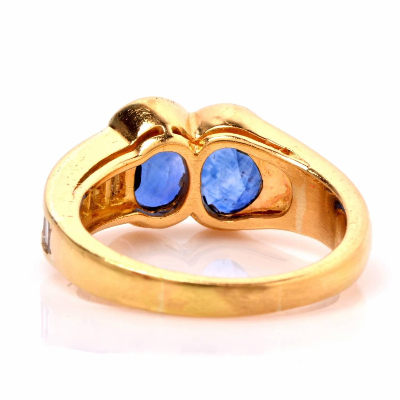 This designer  Van Cleef & Arpels ring  of notable refinement and feminine grace is crafted in 18K yellow gold and weighs 7.1 grams. Designed with romantic inspiration, the ring exposes a duo of heart shape blue sapphires, immaculately mounted