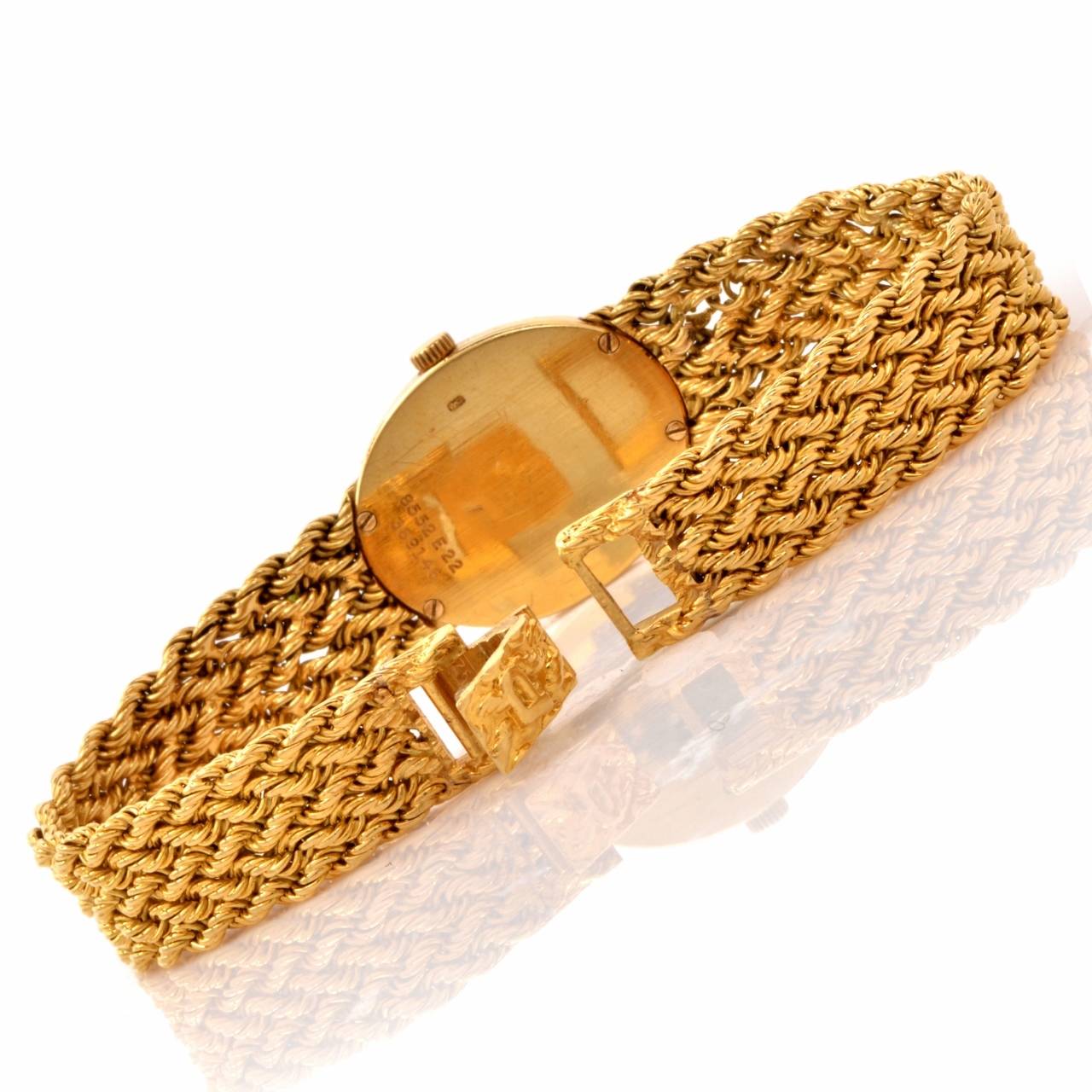 This authentic ladies' vintage ca 1970's  Piaget wristwatch of unsurpassed refinement and aesthetic beauty   is crafted in solid 18K yellow gold and features  an ovular yellow gold case embellished with a twisted rope design border, matching the