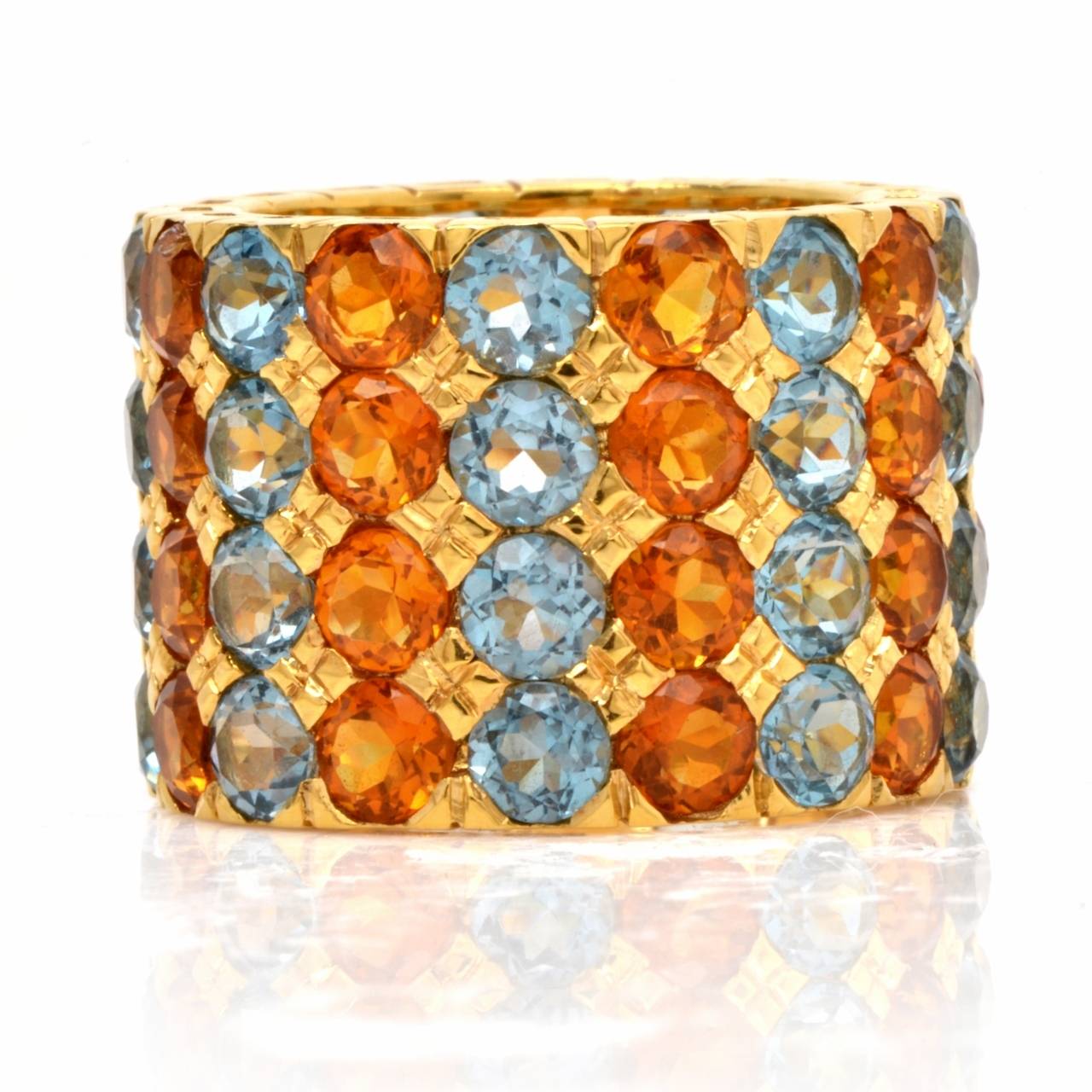 This immaculately crafted  wide band  of vivacious aesthetic and artful craftsmanship is constructed in solid 18K yellow gold, weighs 14.00 grams and measures 17 mm wide.   This colorful  band is adorned with 8 vertical rows of  32 round-faceted