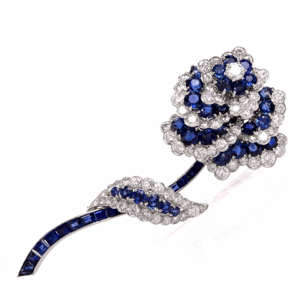 This Impressive  Van Cleef & Arpels diamond  and  blue sapphire floral lapel brooch  of breath-taking aesthetic beauty and artistic craftsmanship  is from 1960's  late vintage era, resplendent in 5.22 cts of sparkling round brilliant-cut
