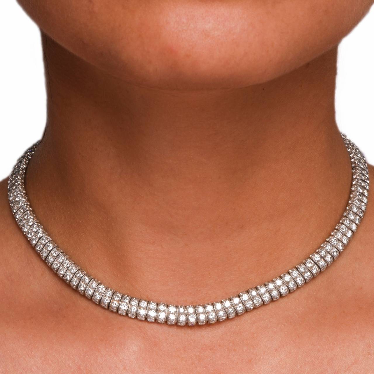 This vintage necklace of classic design is crated in solid platinum, incorporates 115 flexible links each exposing 4 round-faceted diamonds on 3 dimensions of the necklace. The total number of 460 constituent  diamonds prong-set throughout the