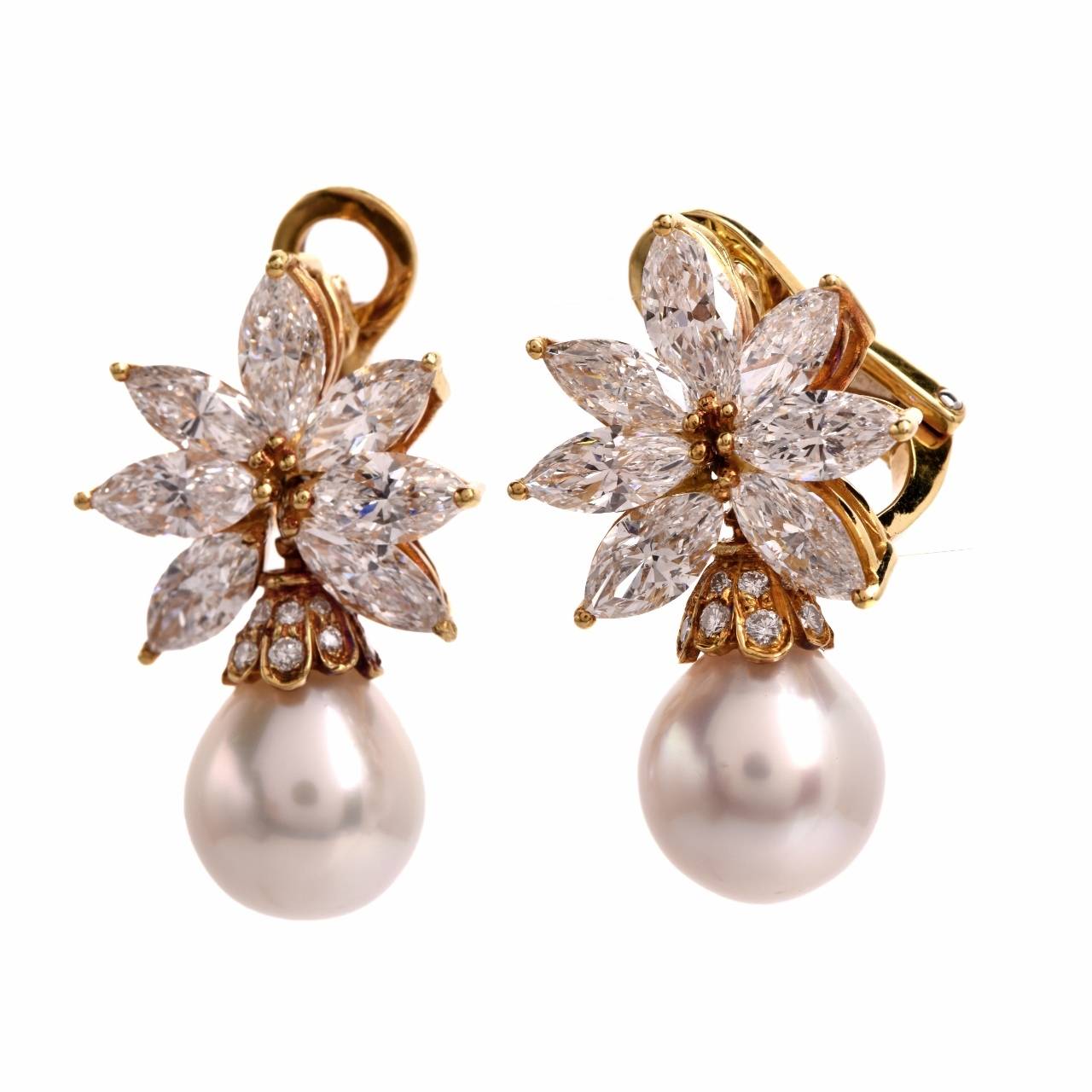 These allurifng estate earrings are crafted in solid 18K yellow gold  and weigh approx. 15.9  grams. In  distinctly impressive design, these  estate earrings expose a pair of  lustrous 10 mm cultured pearls, of 'white with pinkish-cream hue' color, 
