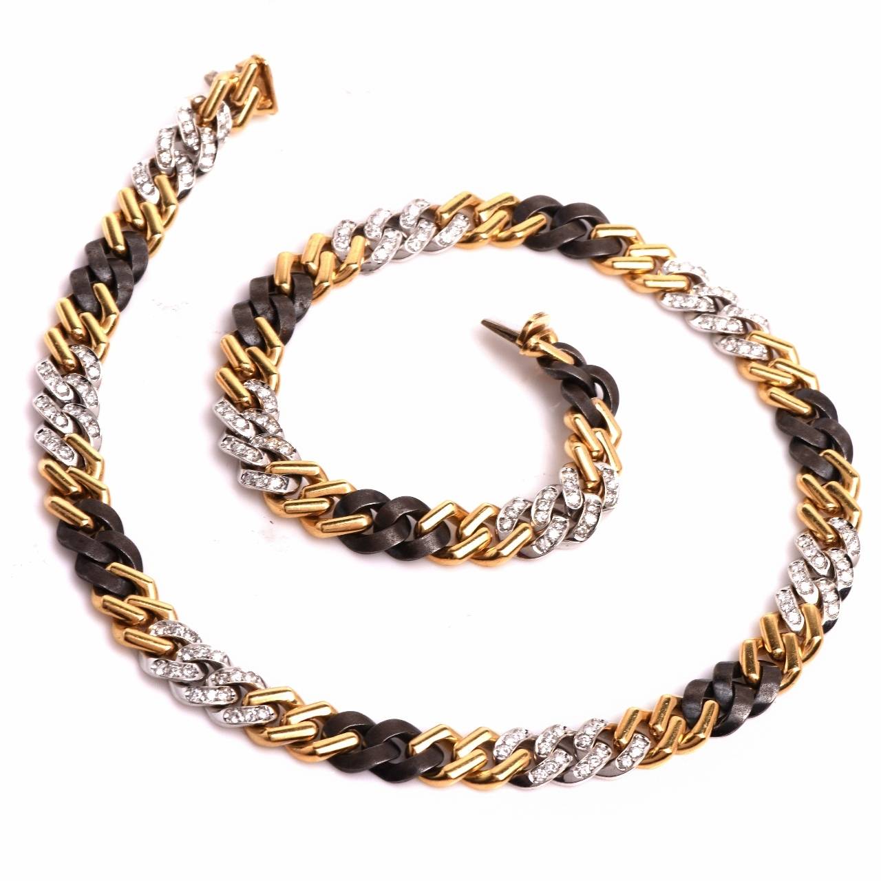 This captivating late vintage 1970's  necklace of immaculate workmanship is crafted in a combination of 18K yellow, white and black  gold, weighing 68.3 grams and measuring 16