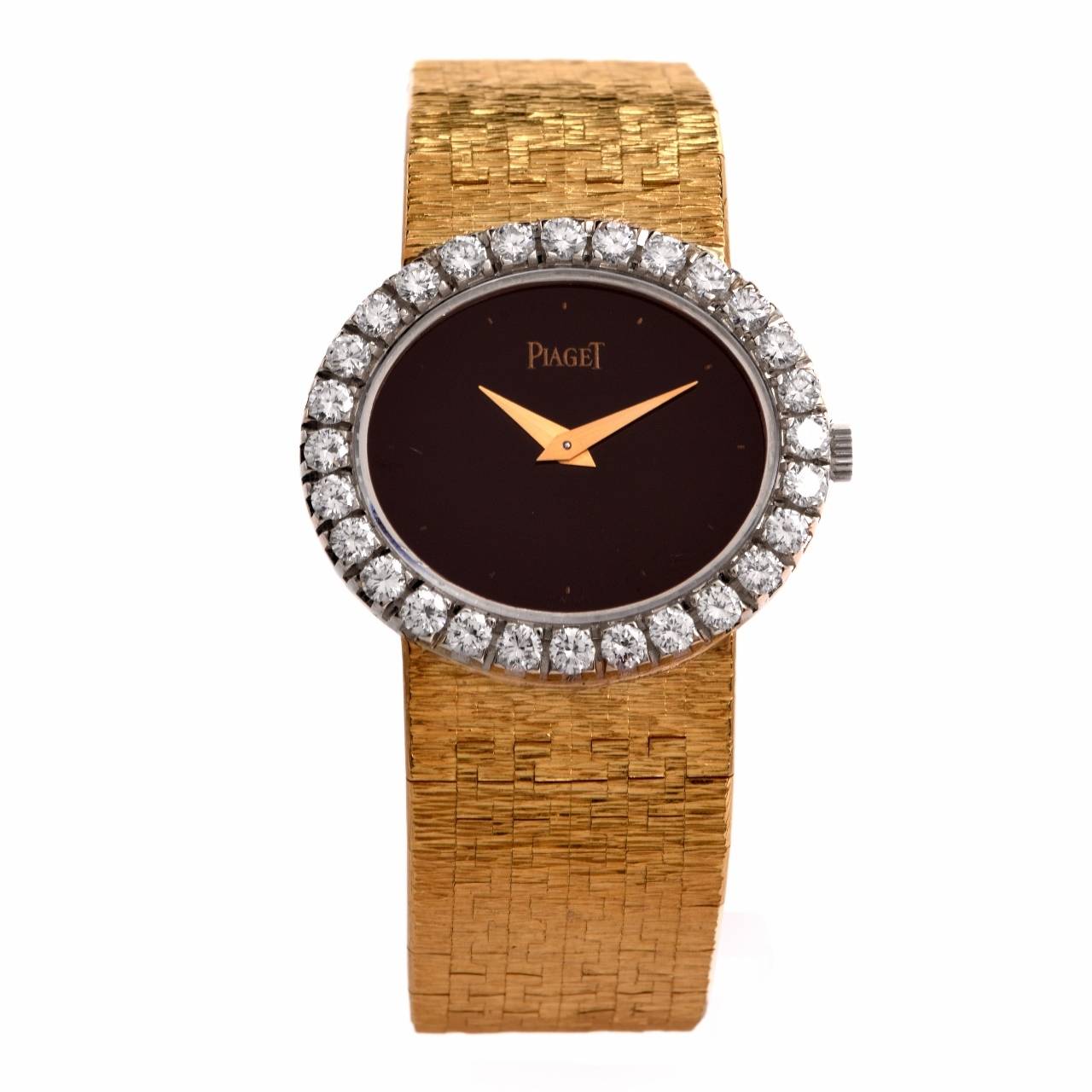 This authentic  all original ladies' vintage ca 1960's Piaget wristwatch of unsurpassed refinement and aesthetic beauty is crafted in solid artfully textured and matted 18K yellow gold and features an oval yellow gold case enriched with a sparkling