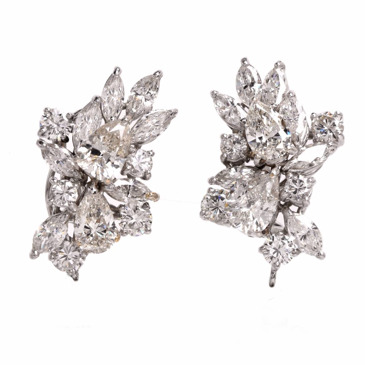 These conspicuous estate pendant earrings of sophisticated aesthetic allure are fashioned in two detachable parts, offering versatility of style, to be worn with or without the diamond and emerald pendant constituent. They are crafted in solid