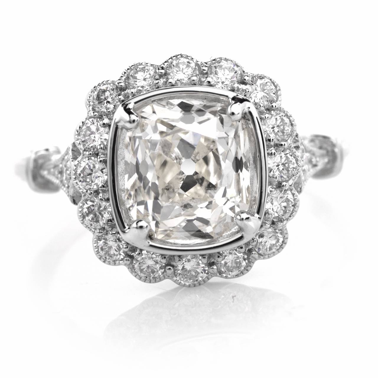 This vintage engagement ring of immaculate design and alluring monochromatic aesthetic is crafted in solid platinum and weighs approx. 5.2 grams. Incorporating an impressive rounded quadrangular plaque, this exquisite engagement ring exposes at the