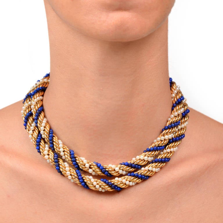 This necklace of artistic craftsmanship with seed pearls and lapis lazuli beads is crafted in solid 18K yellow gold, weighing approx. 155.8 grams and measuring 30” long. This captivating necklace of antique flair incorporates  3 strands of seed