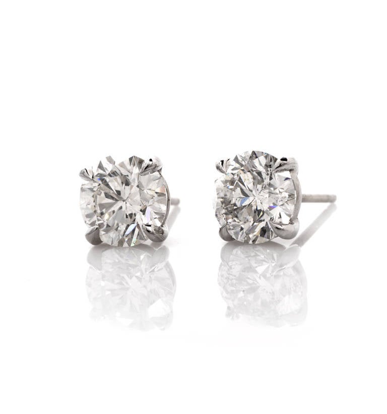 These exquisite diamond stud earrings are crafted in solid 18K white gold, weighing approx. 1.8 grams and measuring 7 mm in diameter. These stunning earrings expose a duo of round brilliant-cut diamonds weighing approx. 2.49ct, graded E color and