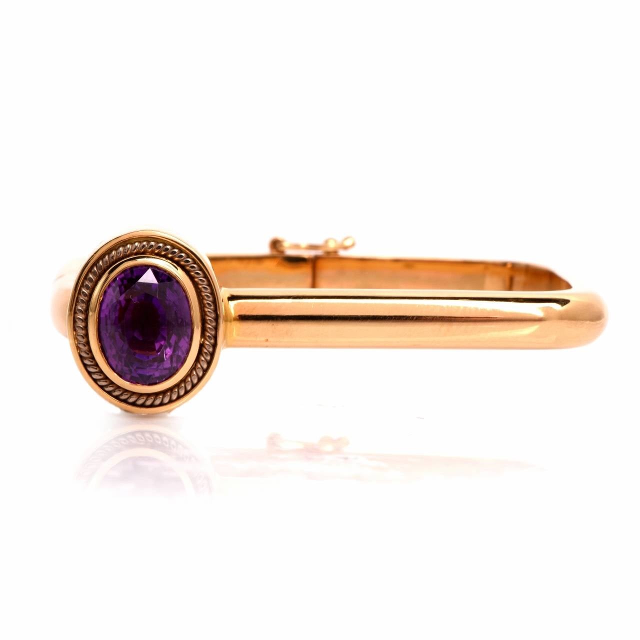 This vintage retro bangle bracelet of impressive avant garde design, is crafted in solid 18K yellow gold and weighs 35.00 grams. The bangle bracelet comprises  three immaculately hinged constituents, the upper one depicting an oval shape decor on