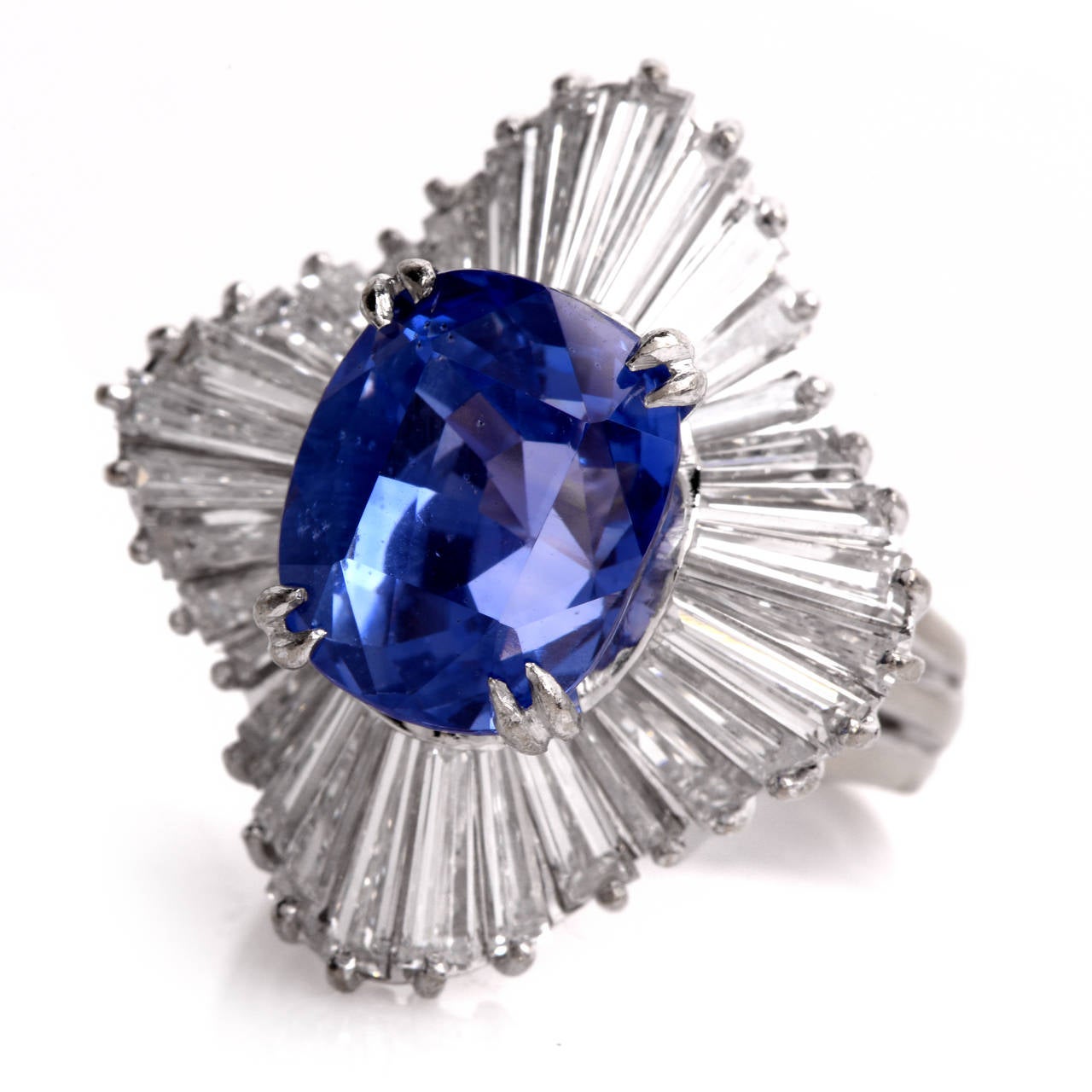 This aesthetically enchanting  estate balerina cocktail  ring with a breath-taking  GIA certified translucent cushion-cut genuine blue sapphire (GIA Report # 1172298517) and tapered  baguette  diamonds is crafted in solid platinum weighs
