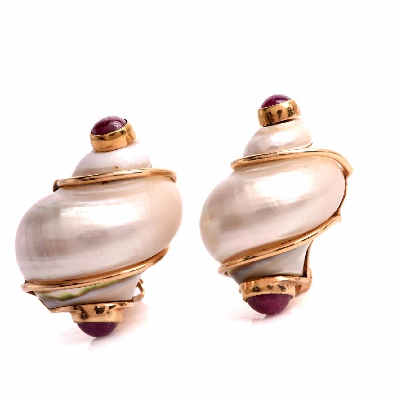 Item #: 6172113

These Seaman Schepps earrings are designed as a pair of (snail) shells, the enchanting spirals rendered in mother of pearl,  with a total number of 4 ruby cabochons, mounted within 14K yellow gold bezel settings. The reverse is