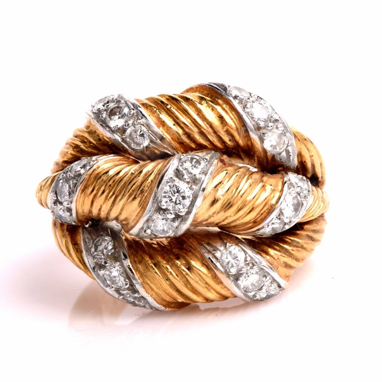 This creatively designed estate cocktail ring simulating triple bands side-by-side, is crafted in artfully textured, 18K yellow gold, weighs 19.00 grams and measures 8 mm high.  The three gracefully domed bands are cumulatively adorned with 21