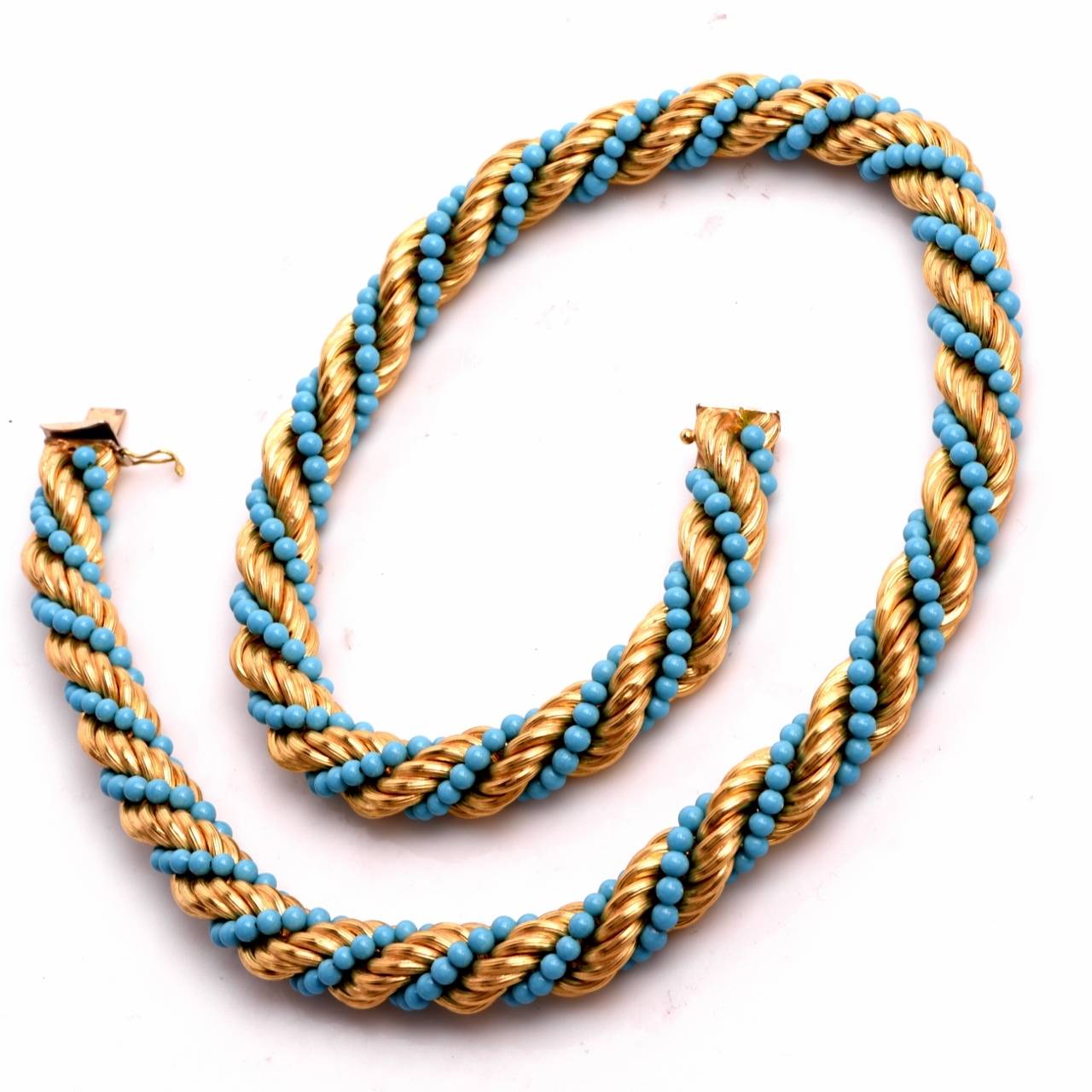 This eye-catching vintage necklace of vivacious aesthetic and immaculate workmanship   is composed of  well-matched  turquoise beads measuring 2 mm in diameter, interwoven with artfully twisted yellow gold wire.It weighs approx. 96.00 grams and