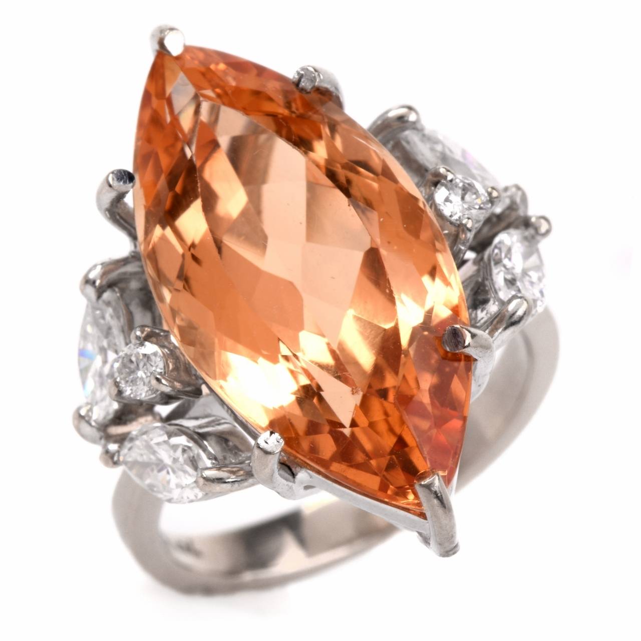 This Vintage cocktail ring with a naturaI and untreated marquise-faceted Imperial topaz of an enchanting intense golden yellow color approx. 10.35, marquise and round-faceted diamonds is crafted in solid 18K yellow gold and weighs 7.2 grams.  The