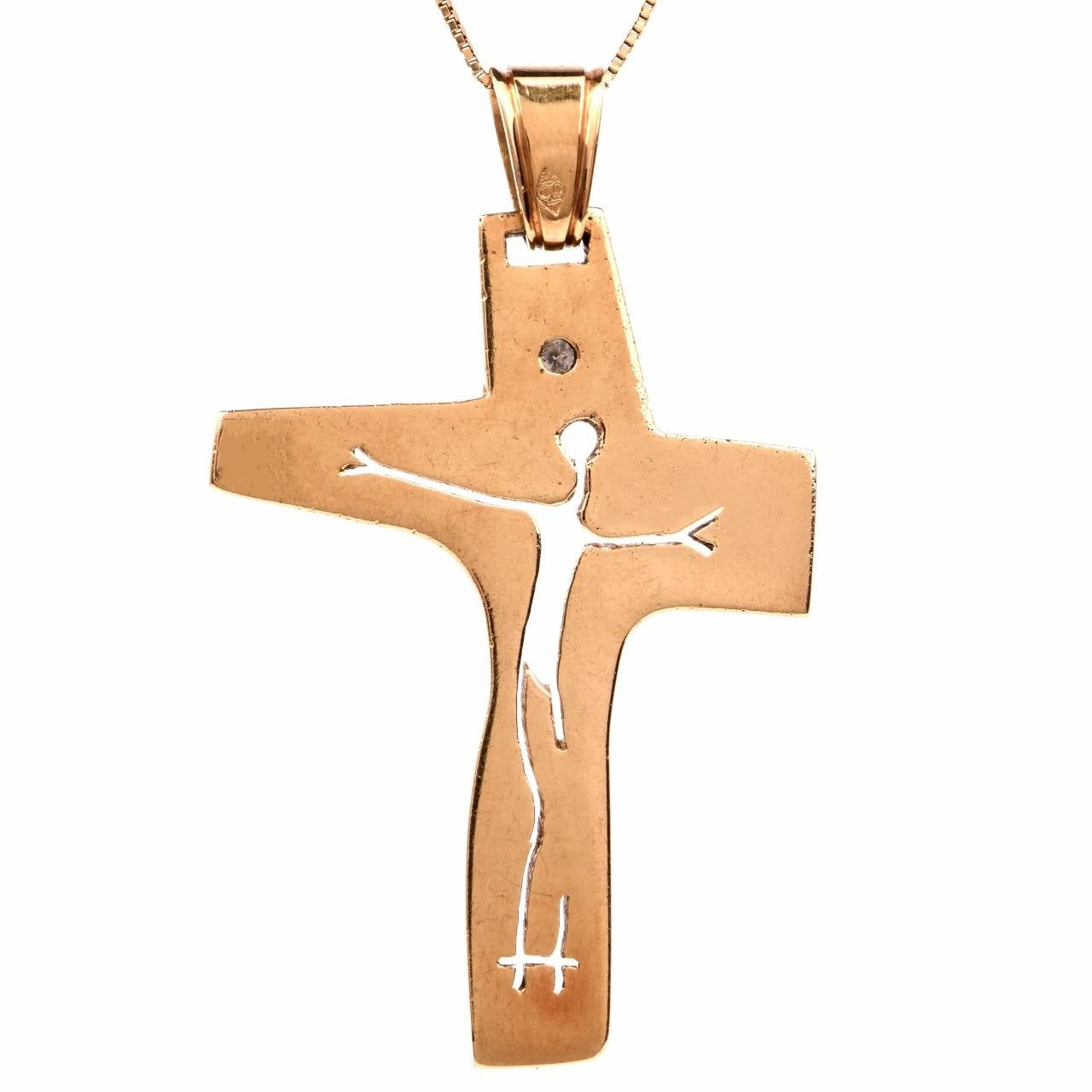 This Estate  cross pendant of unusual asymmetric design with an avant garde openwork silhouette simulating the Crucifix is handcrafted in solid 18K yellow gold, weighing 24.4 grams and measuring  60 x 34 mm (Inclusive of the bale). The creatively