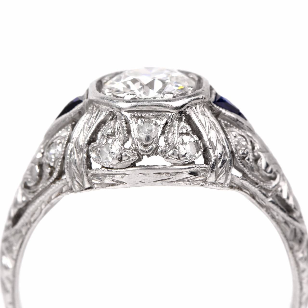 This antique  filigree engagement ring from the 1930's vintage era  is crafted in solid platinum, weighs approximately 3.9 grams and measures 4 mm high. Designed as a subtly  domed  plaque, this authentic  vintage engagement ring exposes a sparkling