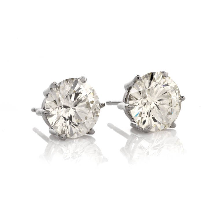These exquisite diamond stud earrings are crafted in solid platinum gold, weighing approx. 6.5 grams and measuring 10mm in diameter. These stunning earrings expose a duo of round brilliant-cut diamonds weighing approx. 7.95ct, graded K-L color and