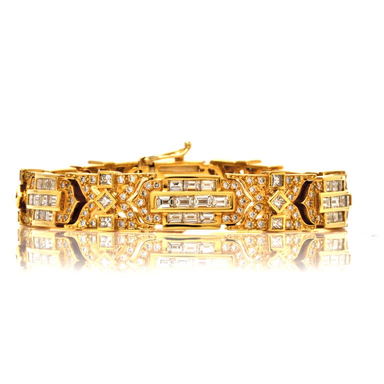 This bracelet of bold and sculptural design is crafted in solid 18K yellow gold and weighs approx. 83.9 grams.  This opulent brcelet incorporates 12 hinged links, exposing geometrically inspired rectangular, quadrangular and  lozenge profiles. These