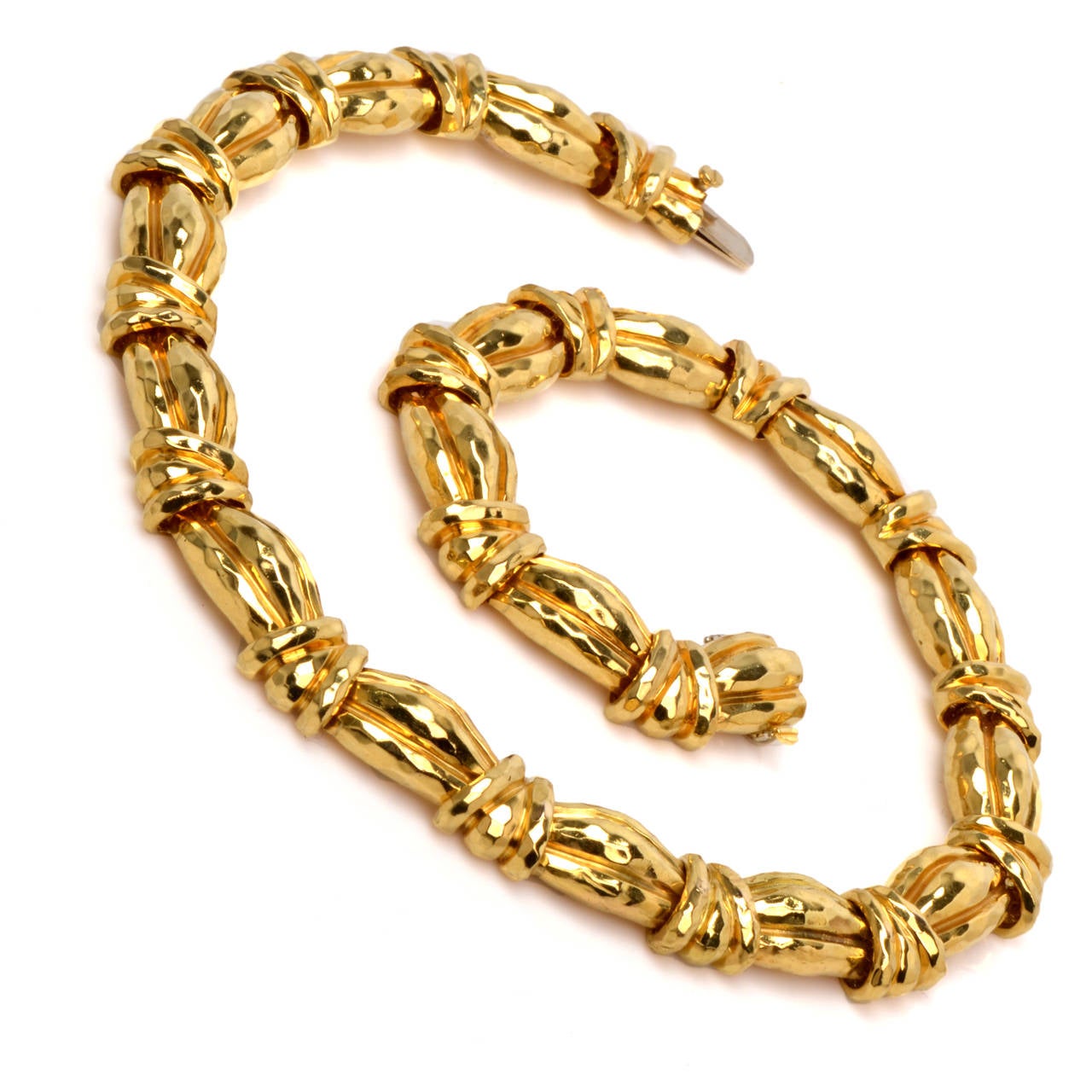 This Henry Dunay necklace of opulent aesthetic and considerable weight is crafted by Dunay Jewelers of Pennsylvania and bears the goldsmith's trademark on the tongue-and-groove clasp. This quintessentially Retro style necklace incorporates  18 