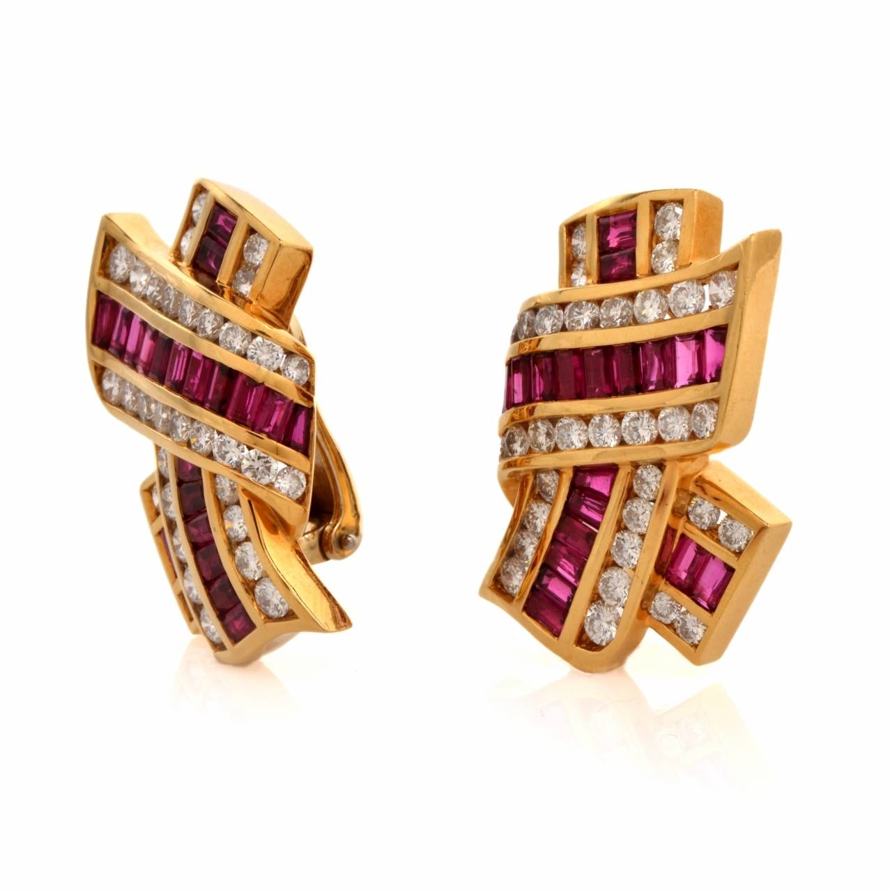 These Charls Krypell earrings with baguette rubies and round-faceted diamonds are crafted in 18K yellow gold. They Designed as a crescent-shaped profile wrapped by a scrolled ribbon, these alluring earrings are resplendent in approx. 7.35 carats of