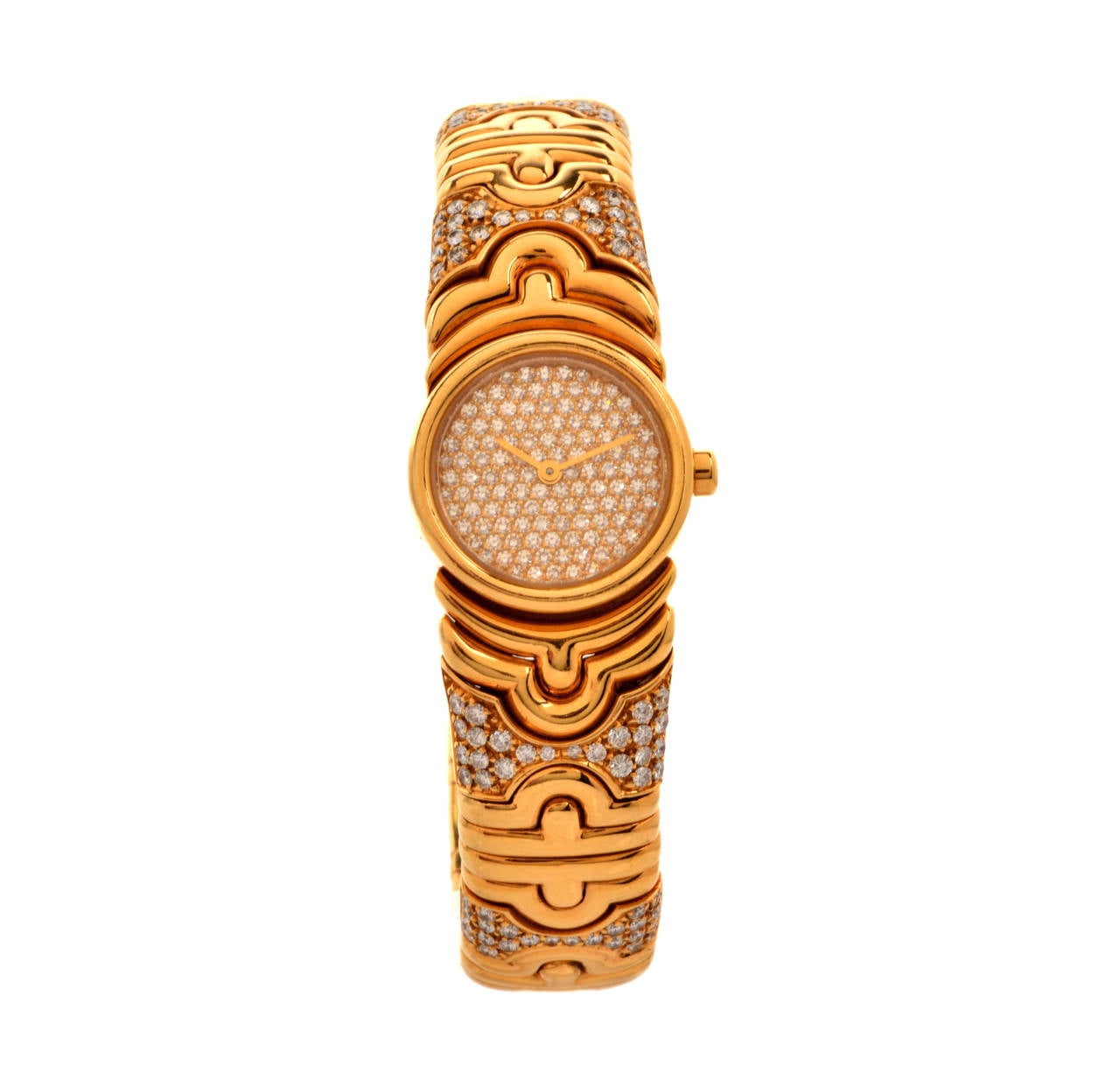 This Bulgari lady's 18k yellow gold and diamond Parentesi bangle bracelet watch weighs 89.2 grams, with approx 5.50 carats of factory-set brilliant-cut diamonds, graded F-G color and VVS1clarity. This watch features a quartz movement, a 20mm case, a