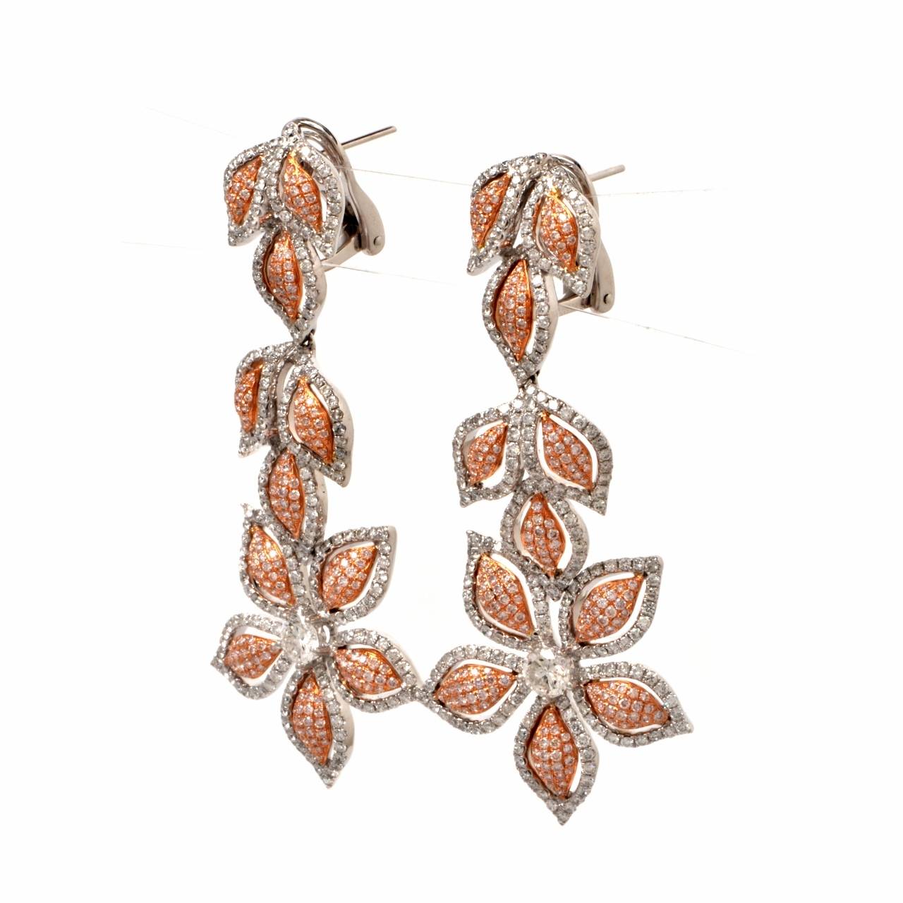 These captivating designer pendant earrings of naturally inspired floral design are crafted in a combination of solid 18K rose and white gold, weighing 28.2 grams and measuring approx. 2.5 inches long and maximum 1" wide. These fascinating