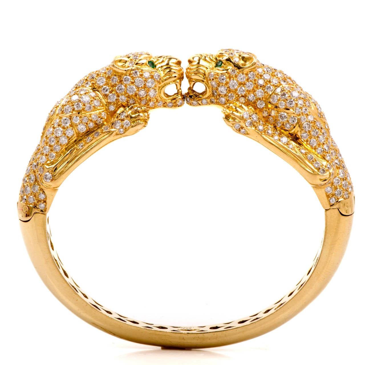 This majestic estate cuff bracelet is crafted in solid 18K yellow gold. This bracelet is accented with some 474 genuine pave set diamonds approx 19.00cttw, G-H color, VS clarity, and detailed at the eyes are 4 genuine natural glistening Colombian