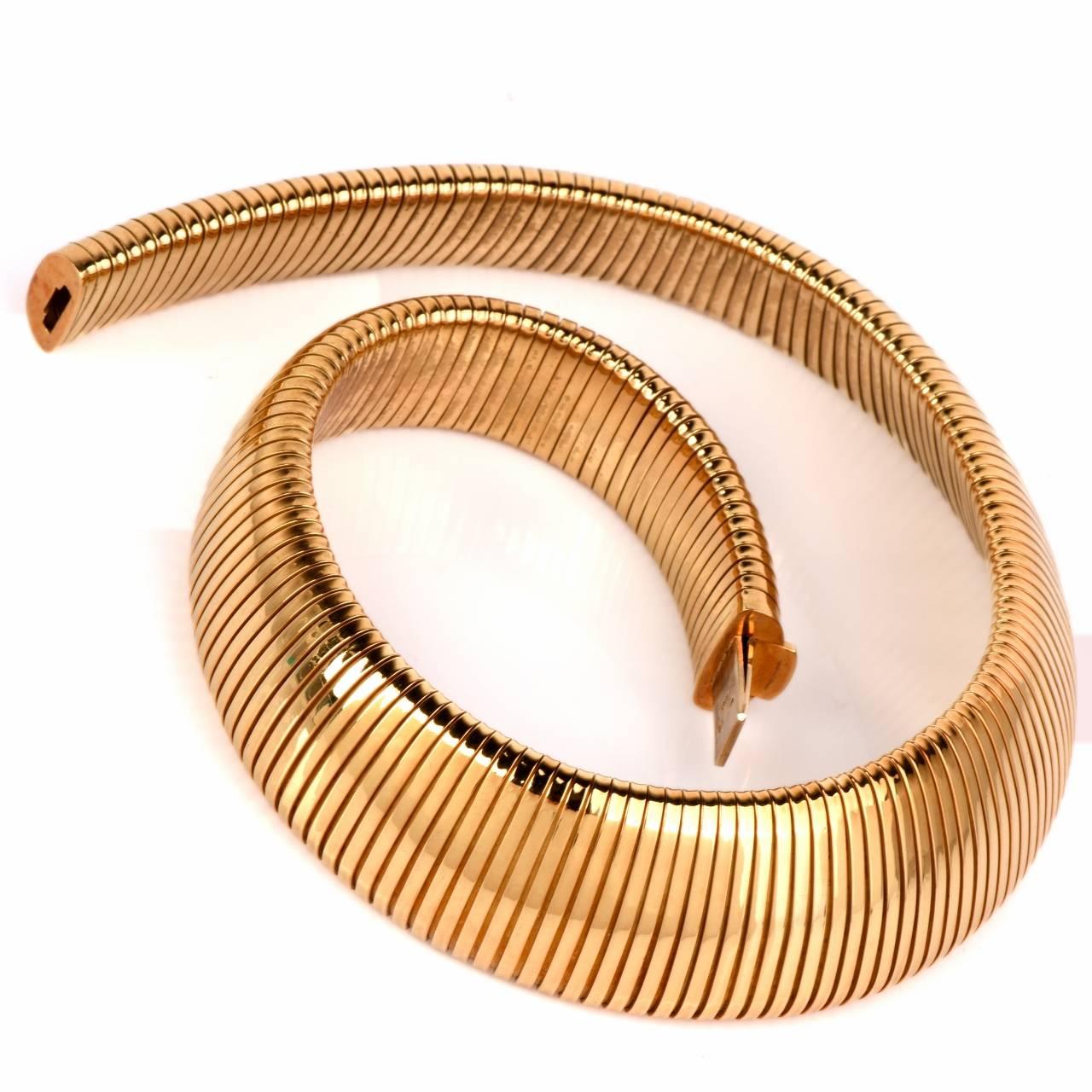 This elegant  Italian estate  snake choker necklace is crafted in solid 18K yellow gold. This flexible necklace exposes a wide design with an insert clasp, making it appear seamless when worn. This is the perfect statement piece for any daily