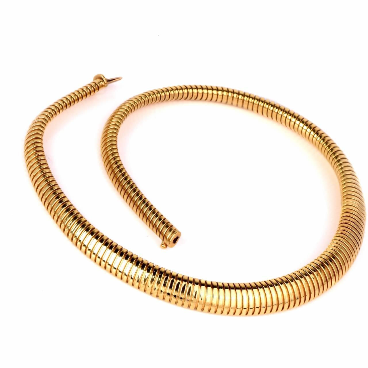 This  classically distinct, yellow gold necklace of 'snake design'  is crafted in solid 18K yellow gold, immaculately textured as a finely ridged pattern to simulate the anatomically accurate skin of a serpent. This style was produced during
