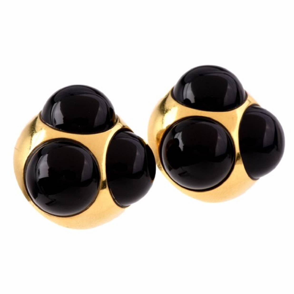 These Tiffany & Co. Paloma Picasso earrings are crafted in solid 18K yellow gold, weighing 35.1 grams and measuring 24 x 10 mm. in bold and sculptural Retro style, these earrings incorporate orbicular plaques each depicting a trio of black onyx