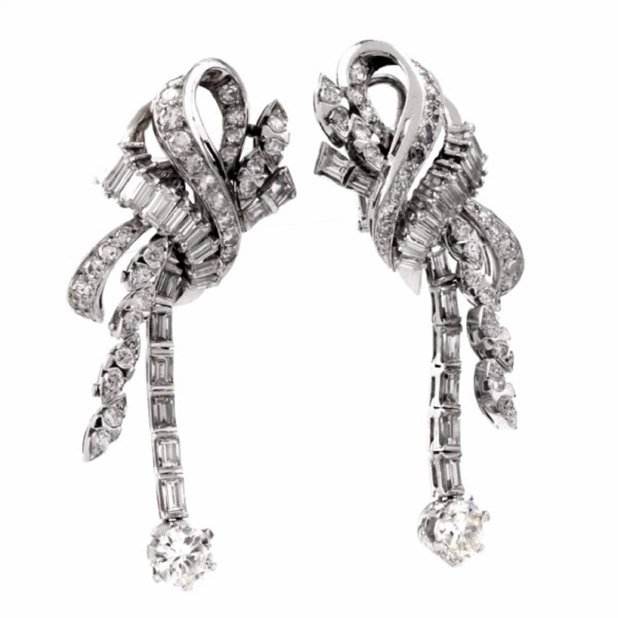 These fabulous vintage cluster drop earrings are crafted in solid platinum, weighing approx: 26.0 Grams and measuring approx: 54mm in length and 19mm in max width. Displaying a spectacular array of genuine round, marquise and emerald cut diamonds