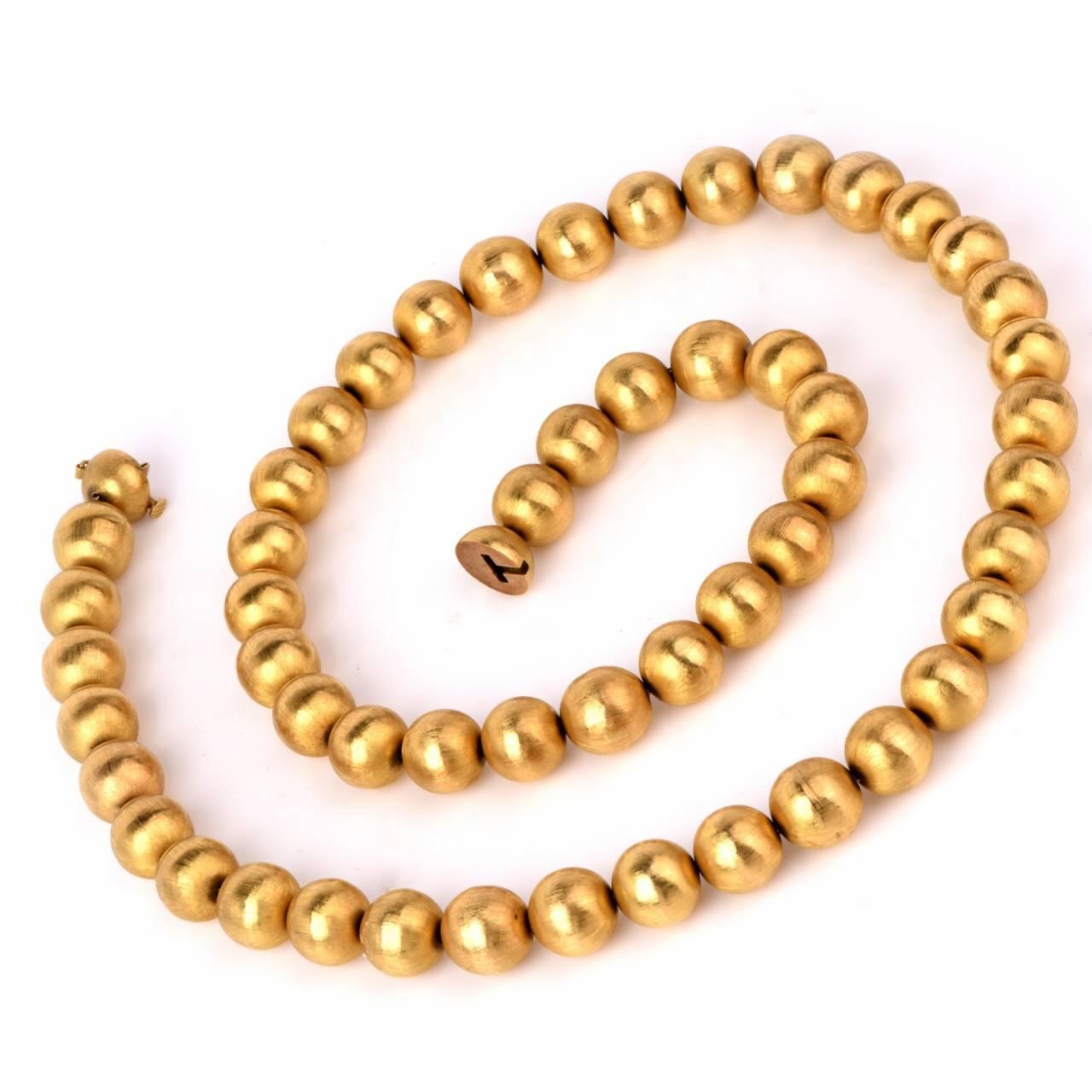 This vintage retro beads necklace is crafted in solid 18K yellow gold weighing approximately 133.10 grams and measures approx. 29 1/2" long. Each bead measures 14mm displaying a satin finish to add to its elegance. The clasp is creatively