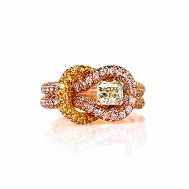 This twisted knot ring is crafted in  solid 18K yellow gold weighing approx: 11.1 grams and measuring approx: 12mm x 7mm. 
Brilliantly displayed in the center is one Rare green diamond,  Certified (GIA Report #128008016) natural fancy intense green