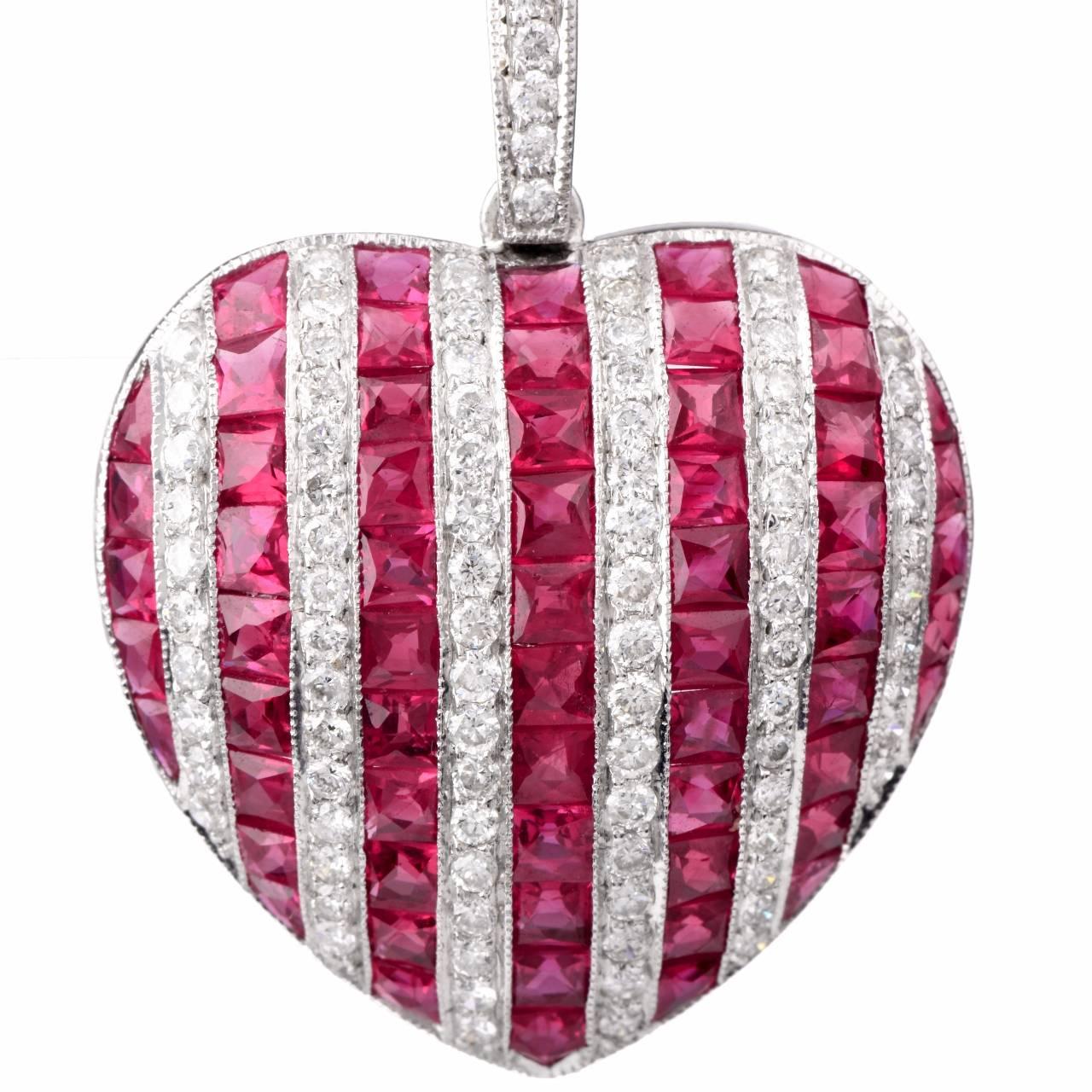 This captivating estate pendant is crafted in solid 18K white gold. Designed as an enchanting diamond and ruby encrusted heart motif profile, this vividly colored pendant is adorned with 4.45 cts of crimson-red color, French square-cut rubies,